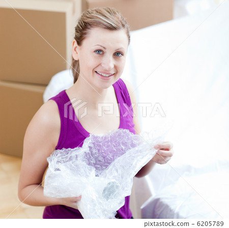 Happy woman unpacking box Happy woman unpacking box 6205789