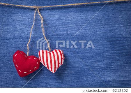 two textile hearts over wooden wall 6212802