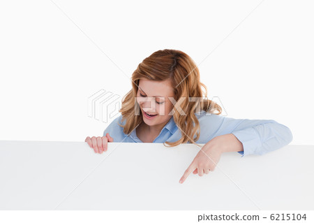 Attractive blond-haired woman standing behind a white board Attractive blond-haired woman standing behind a white board 6215104