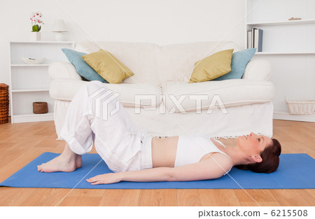 Gorgeous red-haired female stretching in the living room Gorgeous red-haired female stretching in the living room 6215508