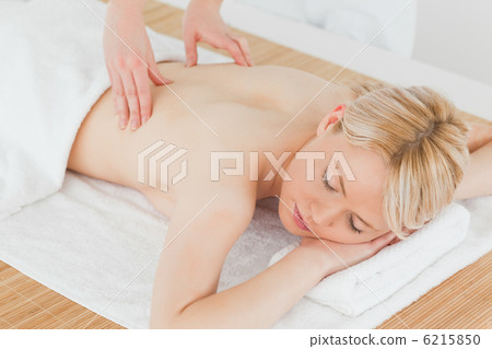 Closeup of young gorgeous blonde female receiving a back massage 6215850