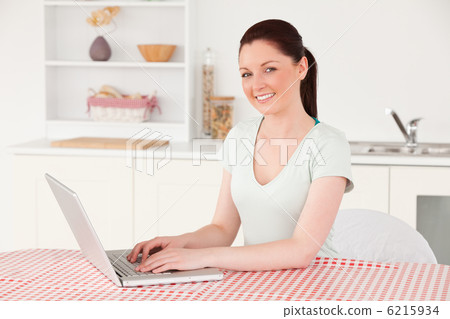 Beautiful woman posing while relaxing with her laptop at lunch t Beautiful woman posing while relaxing with her laptop at lunch t 6215934