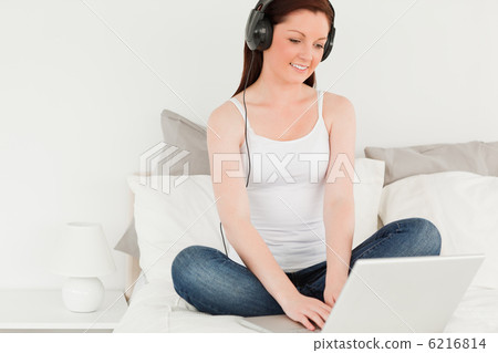 Gorgeous woman relaxing with her laptop Gorgeous woman relaxing with her laptop 6216814