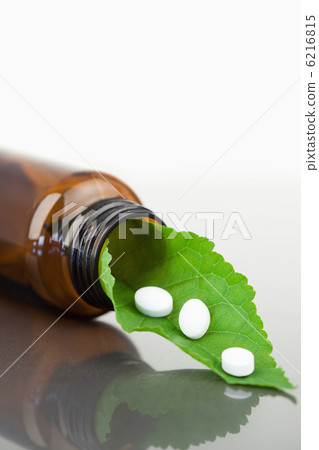 Leaf and pills in a small bottle Leaf and pills in a small bottle 6216815