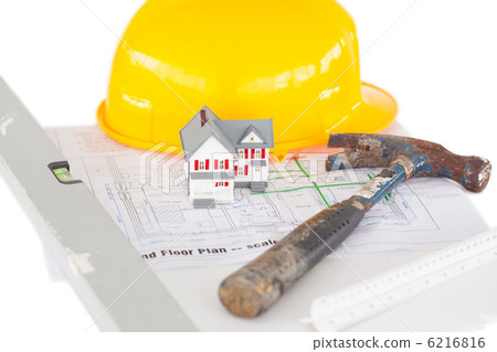 Top view of toy house model with hammer and helmet on a plan Top view of toy house model with hammer and helmet on a plan 6216816