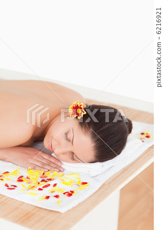 cute woman closing her eyes while surrounded by flowers cute woman closing her eyes while surrounded by flowers 6216921
