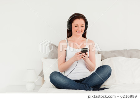Pretty female relaxing with her mp3 Pretty female relaxing with her mp3 6216999