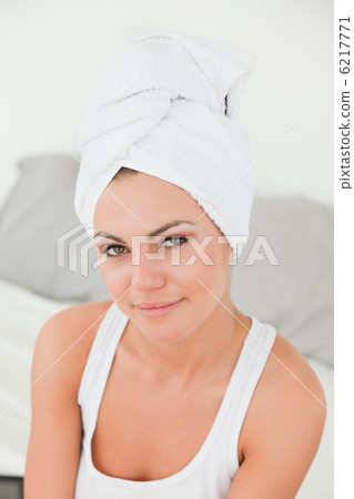 Portrait of a woman with the hair wrapped into a towel Portrait of a woman with the hair wrapped into a towel 6217771