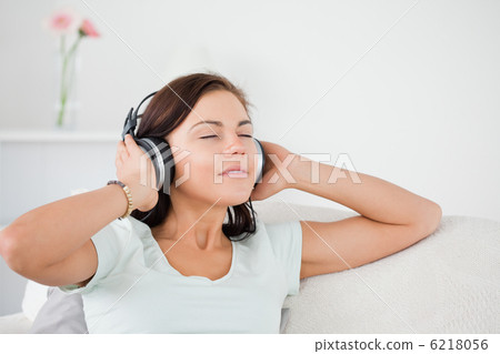 Charming dark-haired woman listening to music Charming dark-haired woman listening to music 6218056
