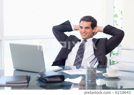Relaxed businessman working with a laptop Relaxed businessman working with a laptop 6218643