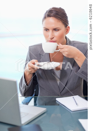Portrait of a serious businesswoman drinking coffee Portrait of a serious businesswoman drinking coffee 6218648