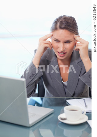 Portrait of a tired businesswoman having a headache Portrait of a tired businesswoman having a headache 6218649