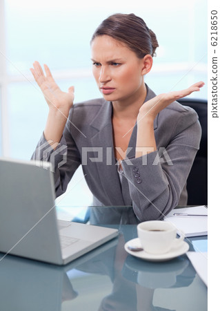 Portrait of an upset businesswoman working with a notebook Portrait of an upset businesswoman working with a notebook 6218650