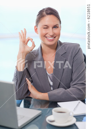 Portrait of a young businesswoman signing that everything is oka 6218651
