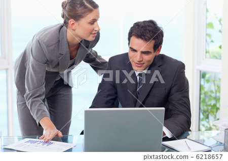 Young business team working with a laptop Young business team working with a laptop 6218657