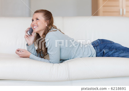 Young woman on the sofa having a nice conversation on the phone 6218691