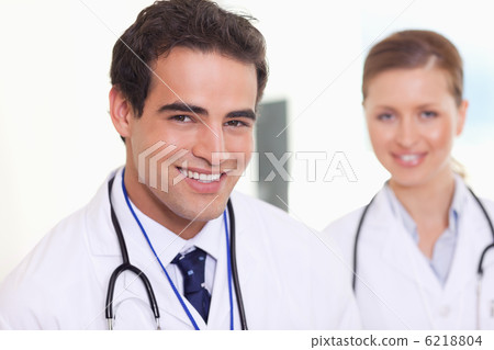 Smiling assistant doctors standing next to each other Smiling assistant doctors standing next to each other 6218804