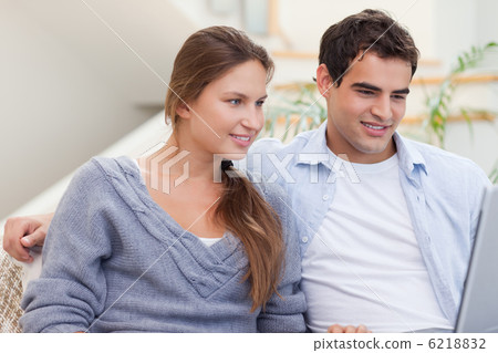Joyful couple using a laptop Joyful couple using a laptop 6218832