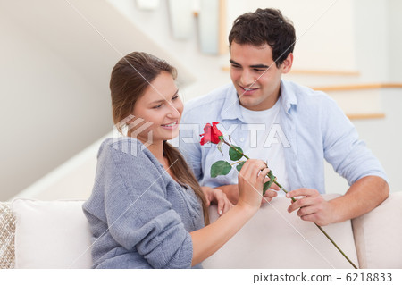 Man offering a rose to his fiance Man offering a rose to his fiance 6218833
