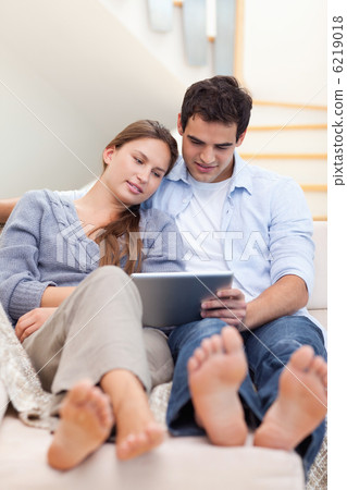Portrait of a couple using a tablet computer Portrait of a couple using a tablet computer 6219018
