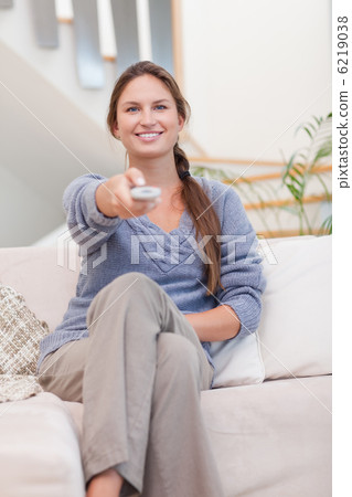 Portrait of a happy woman woman watching TV 6219038