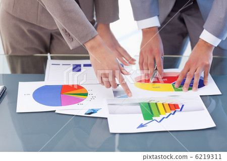 Hands of business people studying statistics Hands of business people studying statistics 6219311