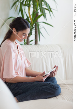 Portrait of a peaceful woman using a tablet computer 6219332