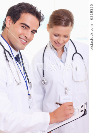 Assistant doctors with patient record Assistant doctors with patient record 6219536