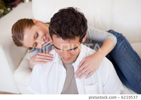 Woman hugging her boyfriend on the couch Woman hugging her boyfriend on the couch 6219537