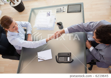 Above view of consultant shaking hands with customer 6219645