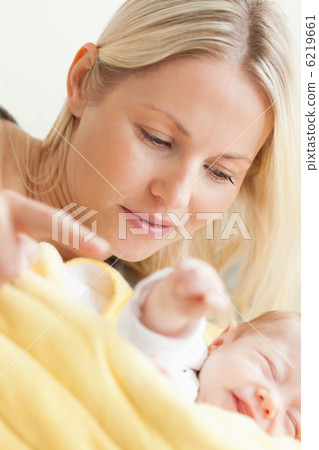 Close up of mother relaxing next to her sleeping baby Close up of mother relaxing next to her sleeping baby 6219661