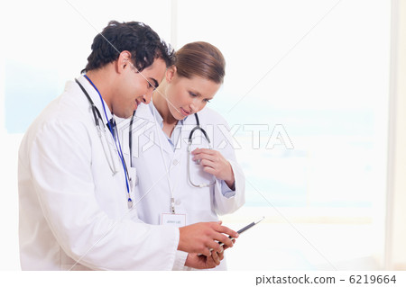 Medical staff looking at clip board Medical staff looking at clip board 6219664