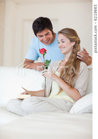 Portrait of a man offering a rose to his fiance 6219665