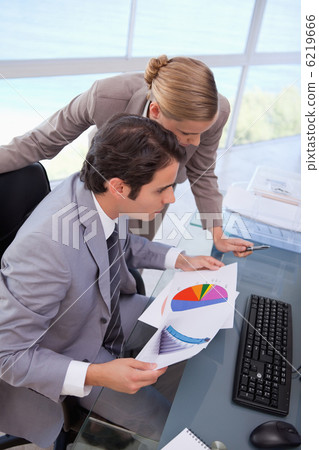 Portrait of a business team looking at a graph 6219666