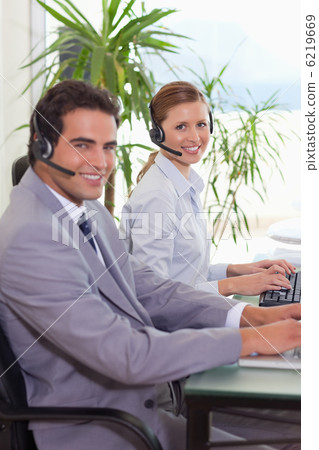 Side view of smiling call center agents 6219669