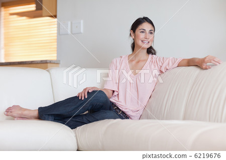 Smiling woman sitting on a couch Smiling woman sitting on a couch 6219676