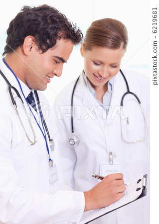 Assistant doctors taking notes Assistant doctors taking notes 6219681