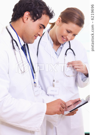 Young assistant doctors using tablet Young assistant doctors using tablet 6219696