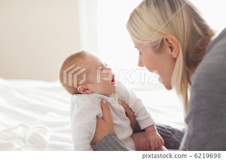 Affectionate mom holding her newborn Affectionate mom holding her newborn 6219698