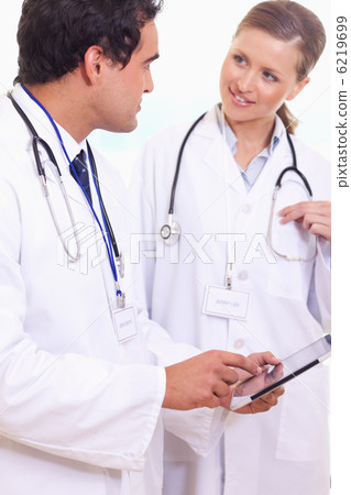 Assistant doctors talking about what's on the tablet Assistant doctors talking about what's on the tablet 6219699