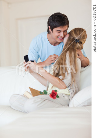 Portrait of a man offering a jewel to his girlfriend Portrait of a man offering a jewel to his girlfriend 6219701