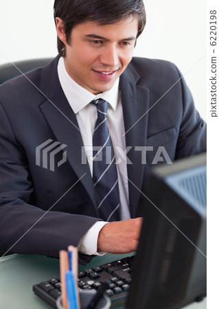 Portrait of a young businessman working with a computer 6220198