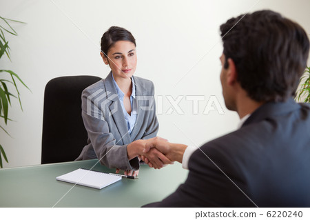 Young manager shaking the hand of a customer Young manager shaking the hand of a customer 6220240