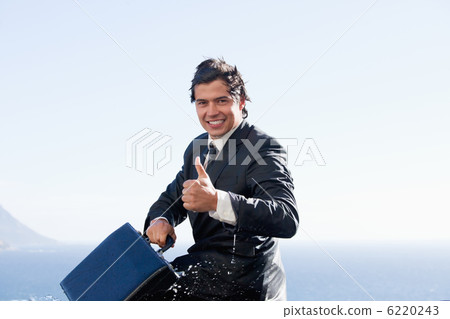 Cheerful businessman with the thumb up Cheerful businessman with the thumb up 6220243