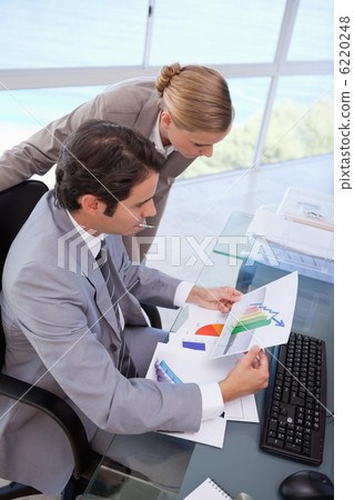 Portrait of a manager and her secretary looking at a graph Portrait of a manager and her secretary looking at a graph 6220248