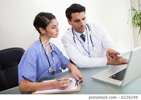 Doctors working with a notebook Doctors working with a notebook 6220249