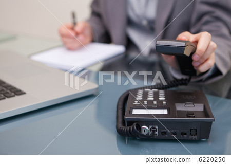 Telephone being hung up by businesswoman Telephone being hung up by businesswoman 6220250