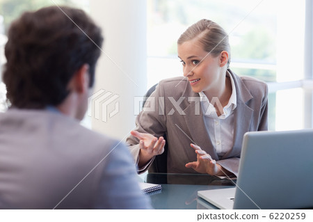 Cute businesswoman receiving a customer Cute businesswoman receiving a customer 6220259