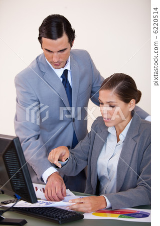Business people looking at statistics together 6220514