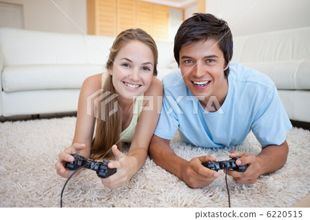 Smiling couple playing video games 6220515